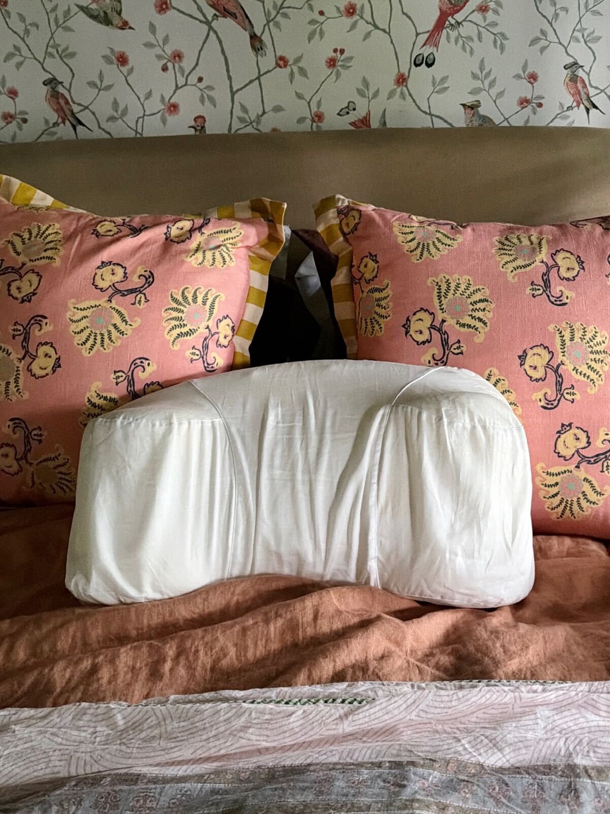Sleep & Glow Aula Pillow sitting on a bed