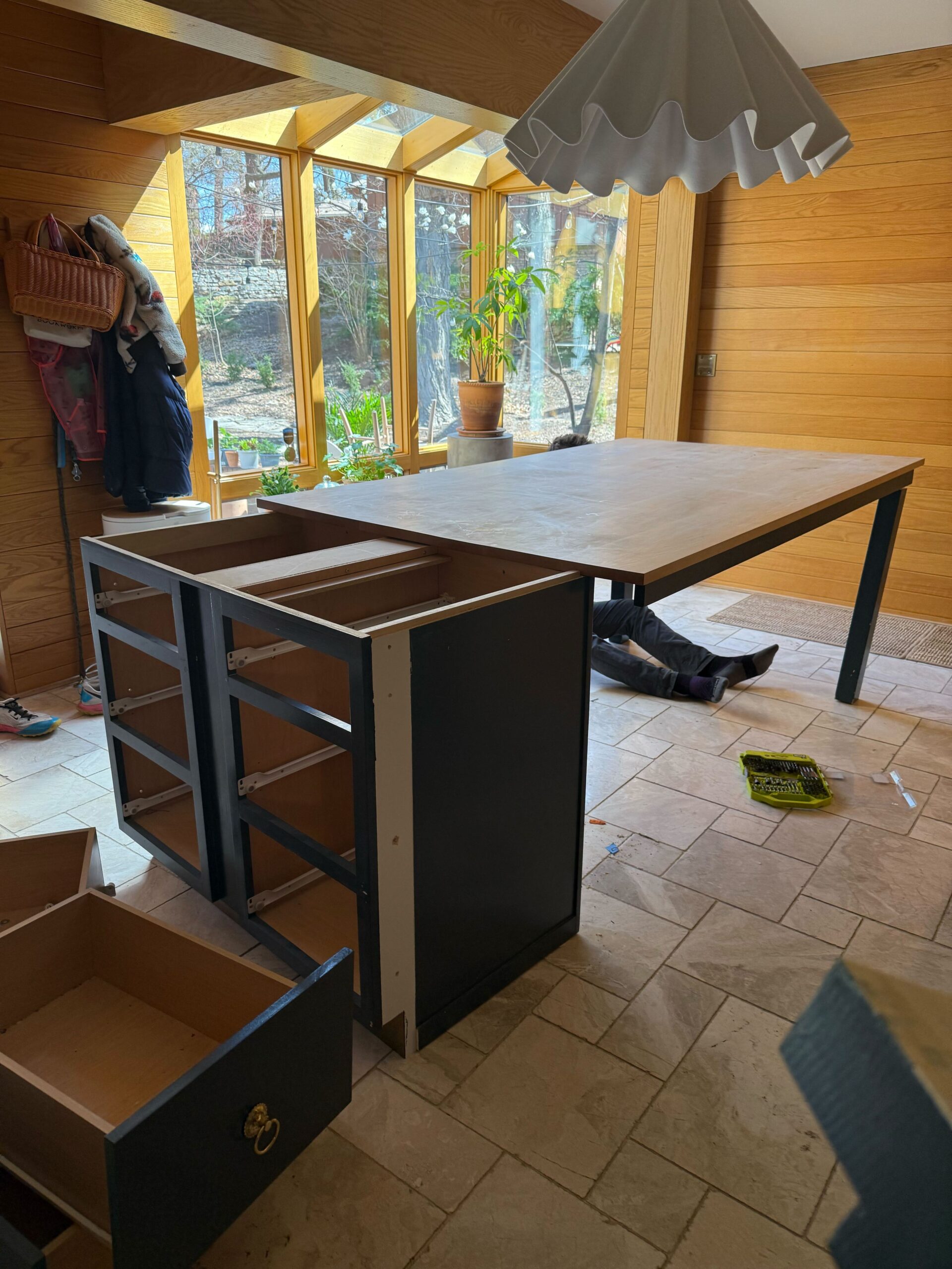 Taking apart a kitchen island in an oak-paneled dining area