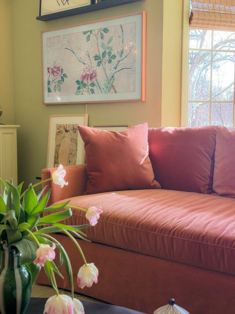Pink sofa in a green family room