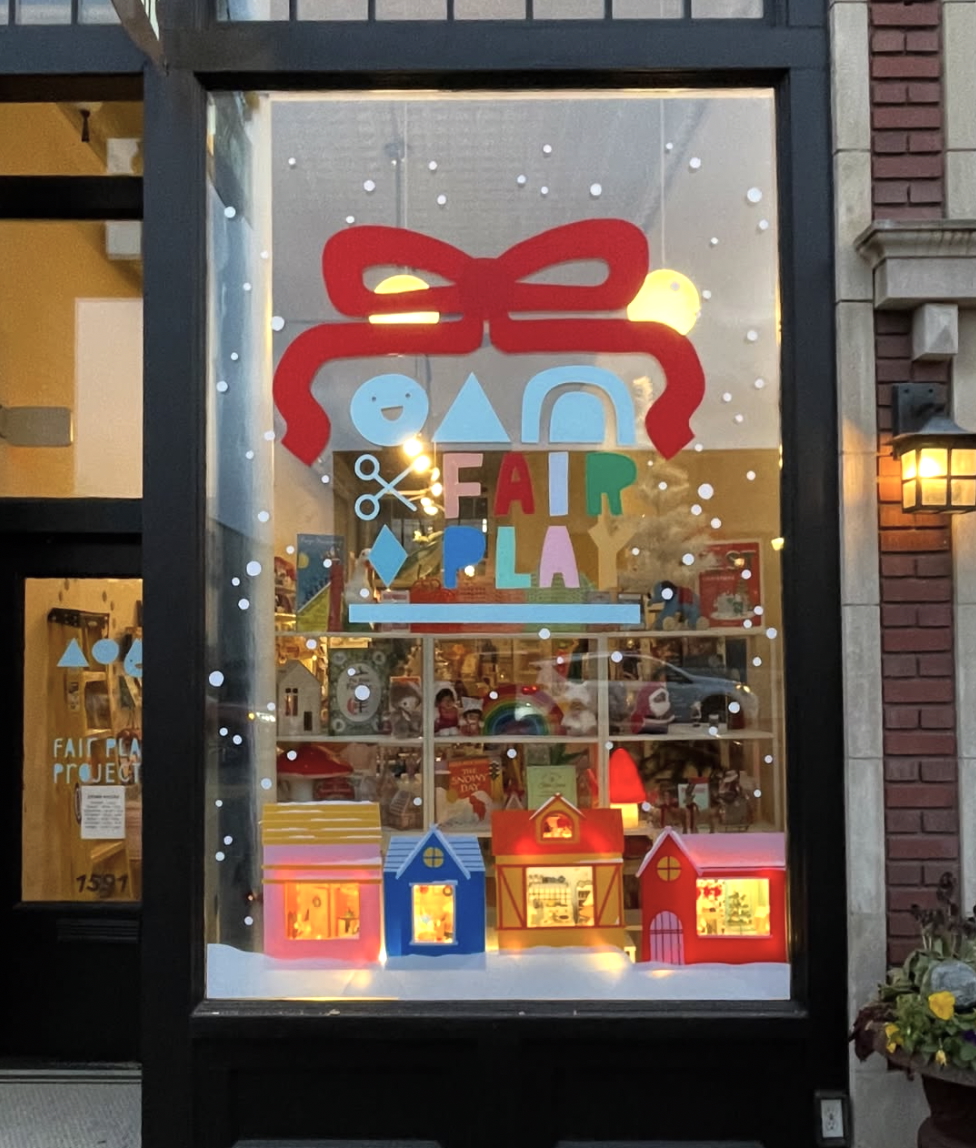 A front window decorated for the holidays at Fair Play kids' shop in St Paul