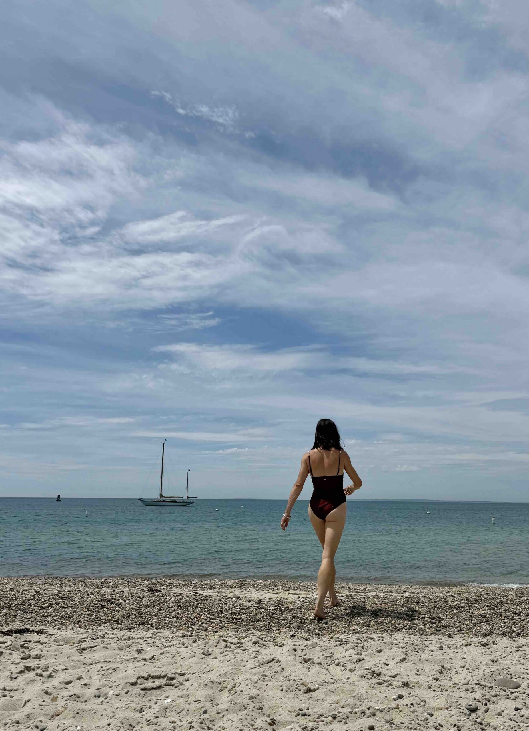a person walking on a marths's vineyard beach