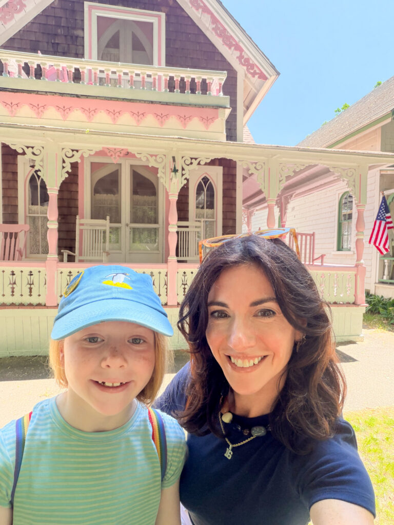 posing in front of a gingerbread cottage in martha's vineyard