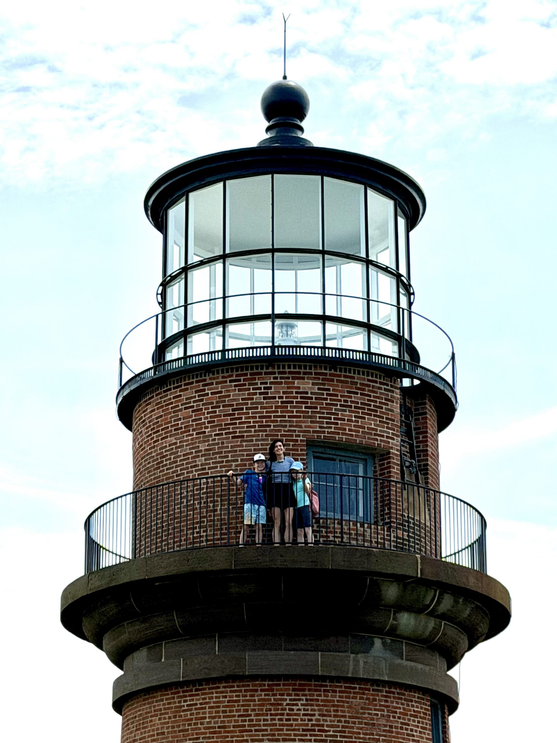 posing on top of gay head lighthouse in martha's vineyard